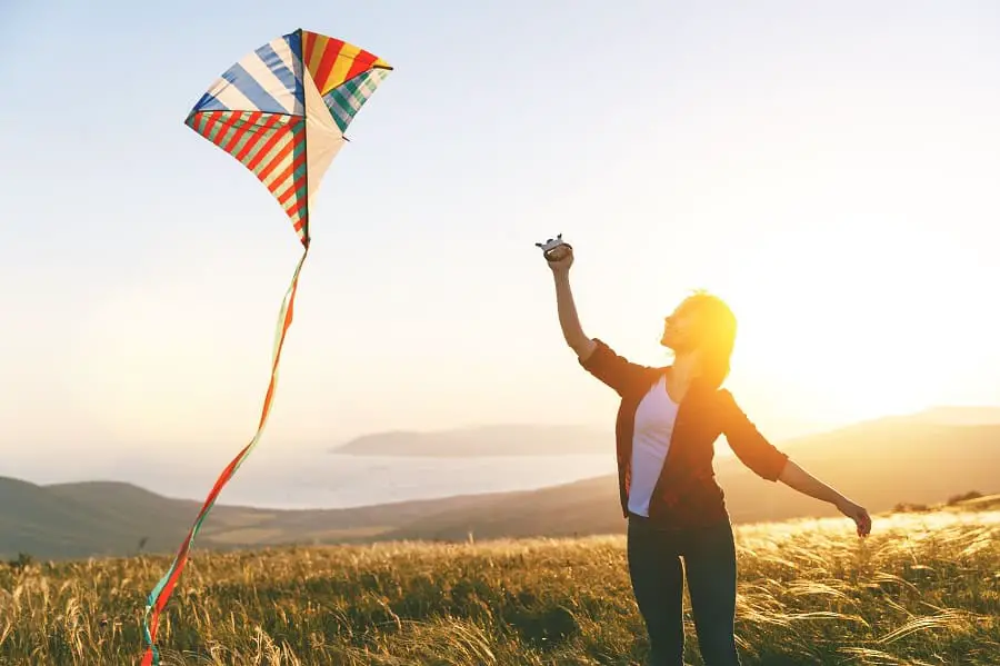 flying a kite on a mountain is adventurous